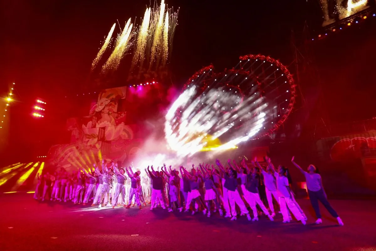 Crowd celebrating under lights and fireworks at a large-scale Singapore event