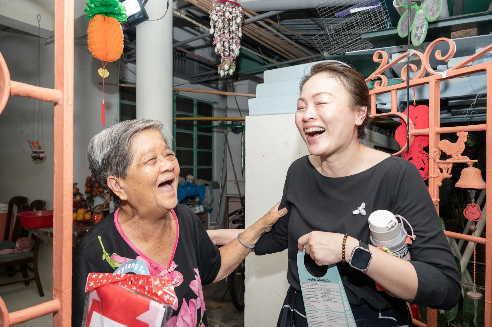 Excellent candid moment-capture — two women in an unforced shared laugh, exactly the 'real moments over posed filler' brand promise