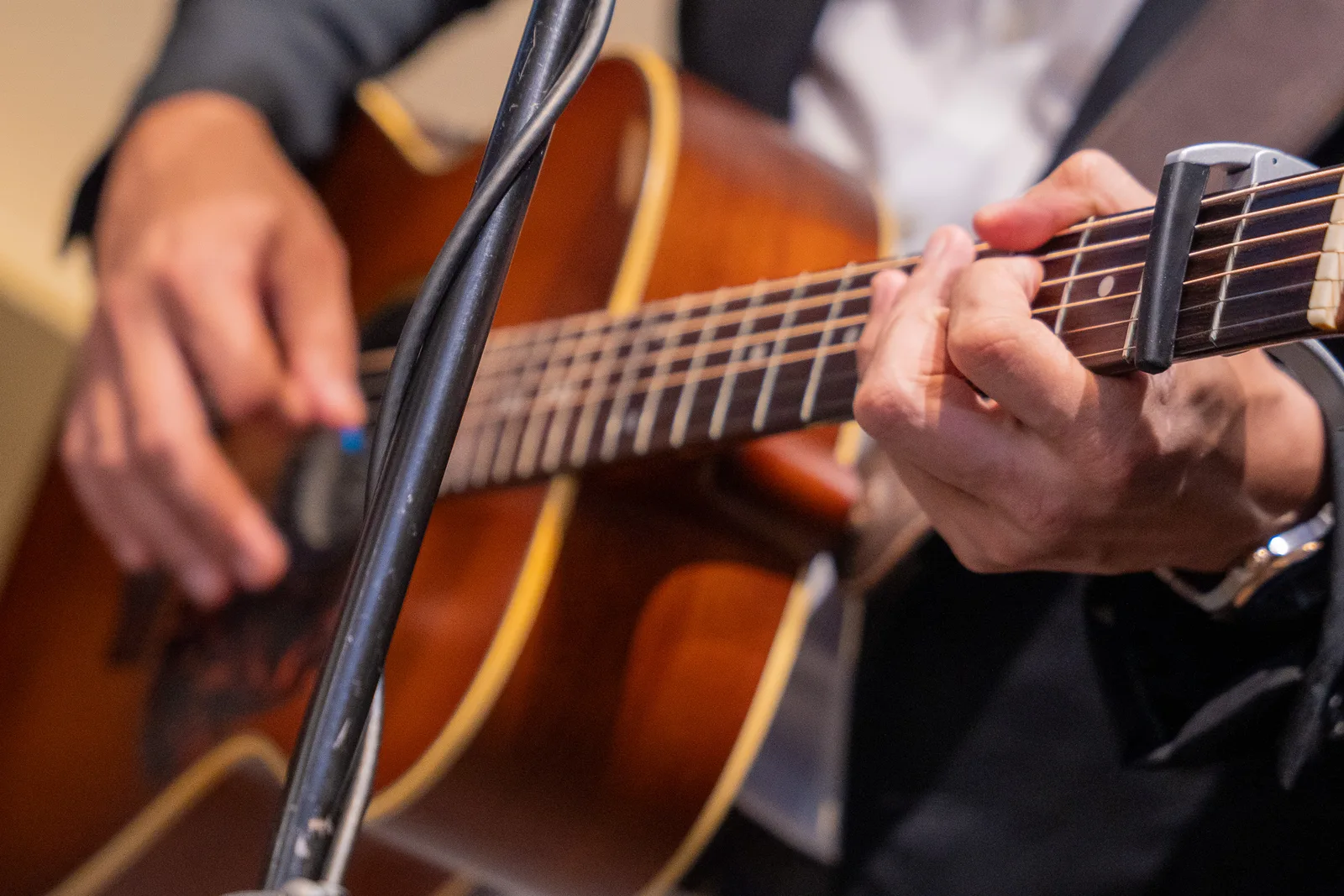Guitar-hands detail with warm tones and shallow depth — good craft and adds variety to his strip, not a standalone seller