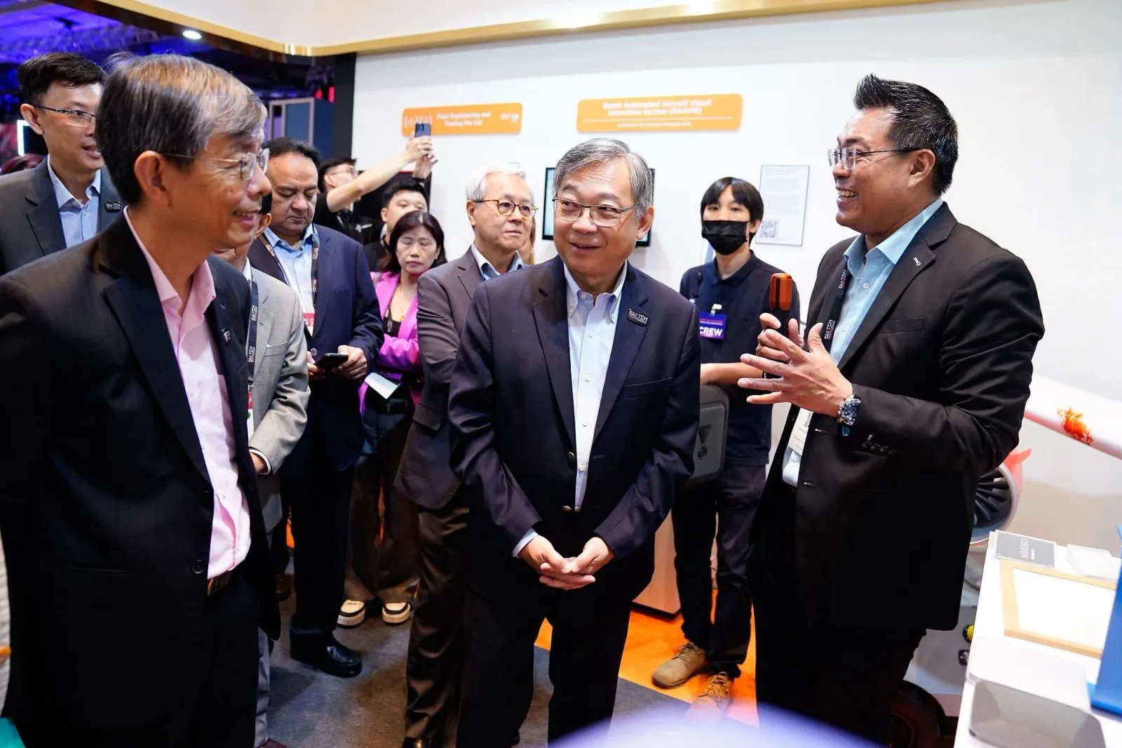 Ministerial delegation being guided through an exhibition showcase