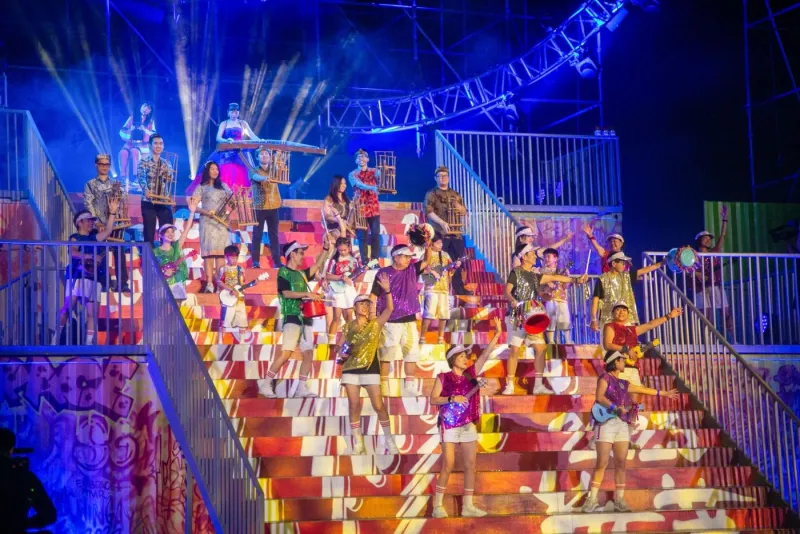 Chingay performers in front of the grandstand at night