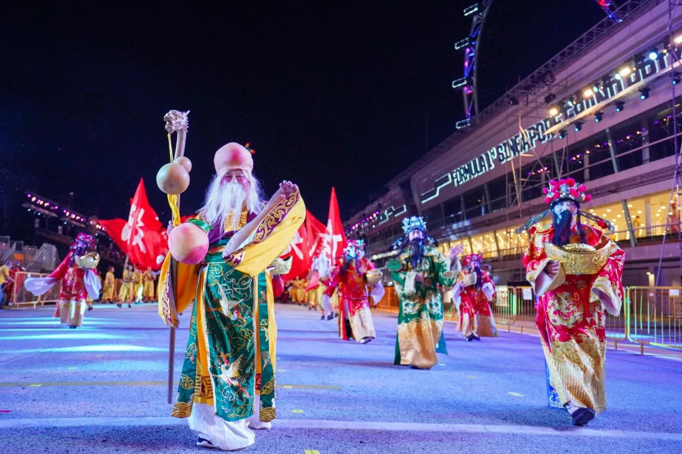God of Fortune character leading a festive night parade