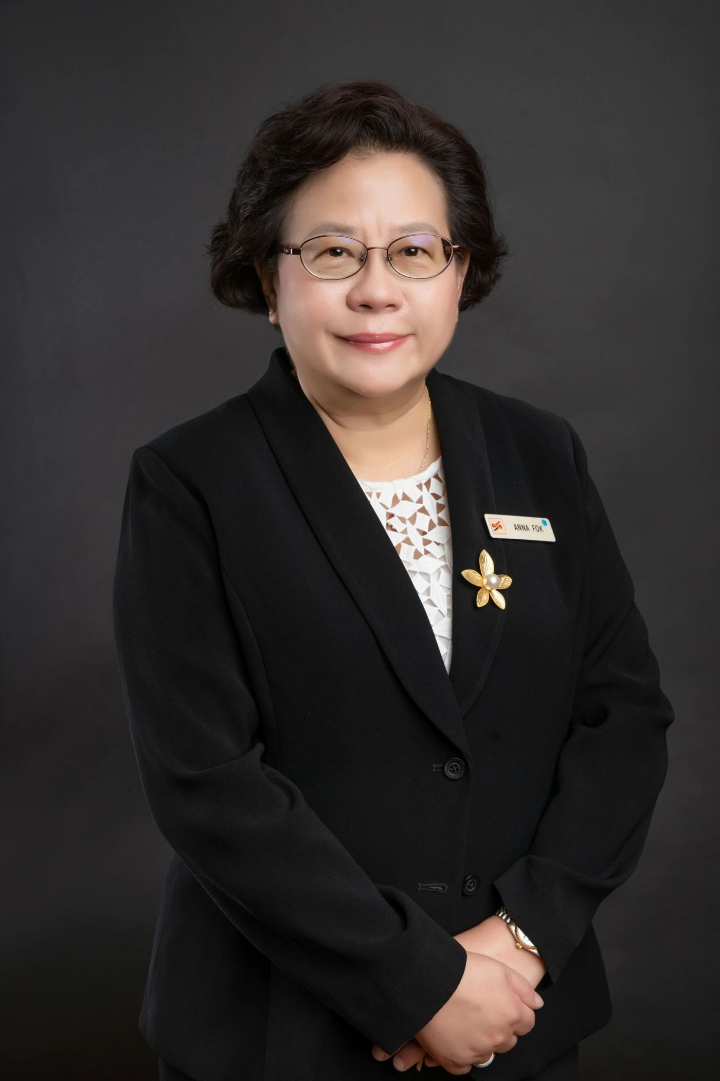 Corporate headshot of an executive against dark backdrop