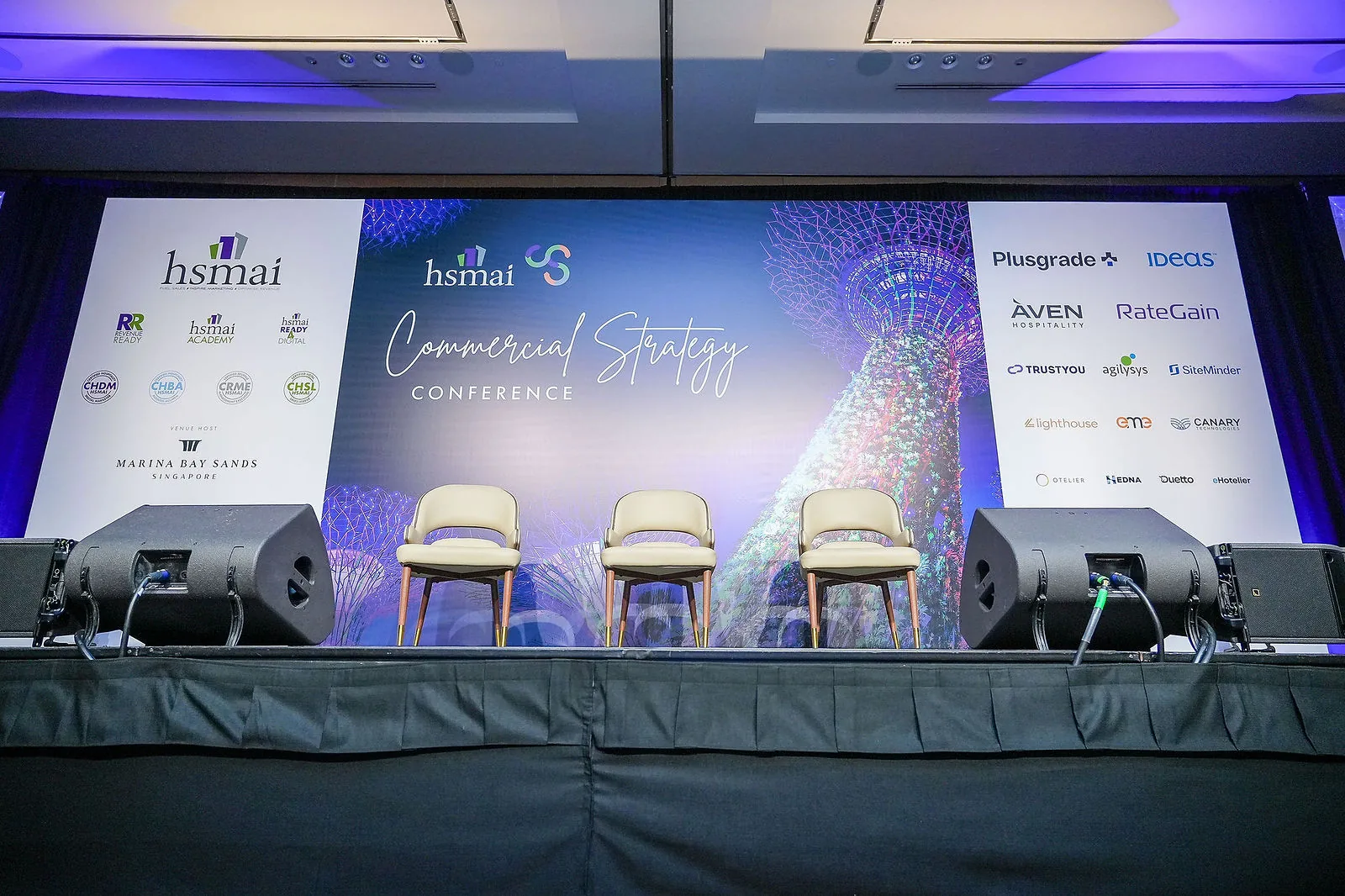 Speakers on stage against a full-width LED backdrop at Marina Bay Sands — RS Photography