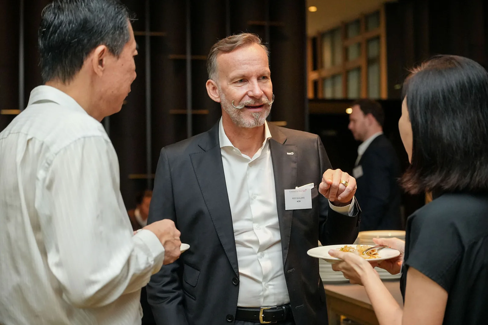Delegates in conversation during a hotel conference break — RS Photography