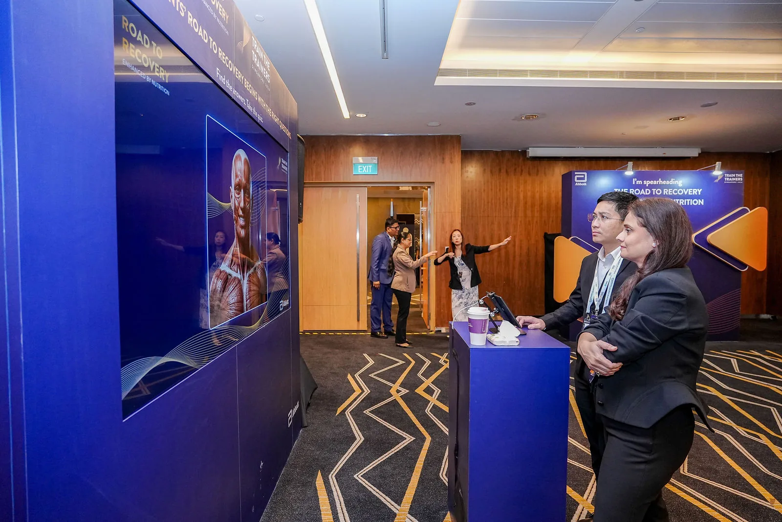 A small group meeting in a Suntec Singapore breakout space during a conference — RS Photography