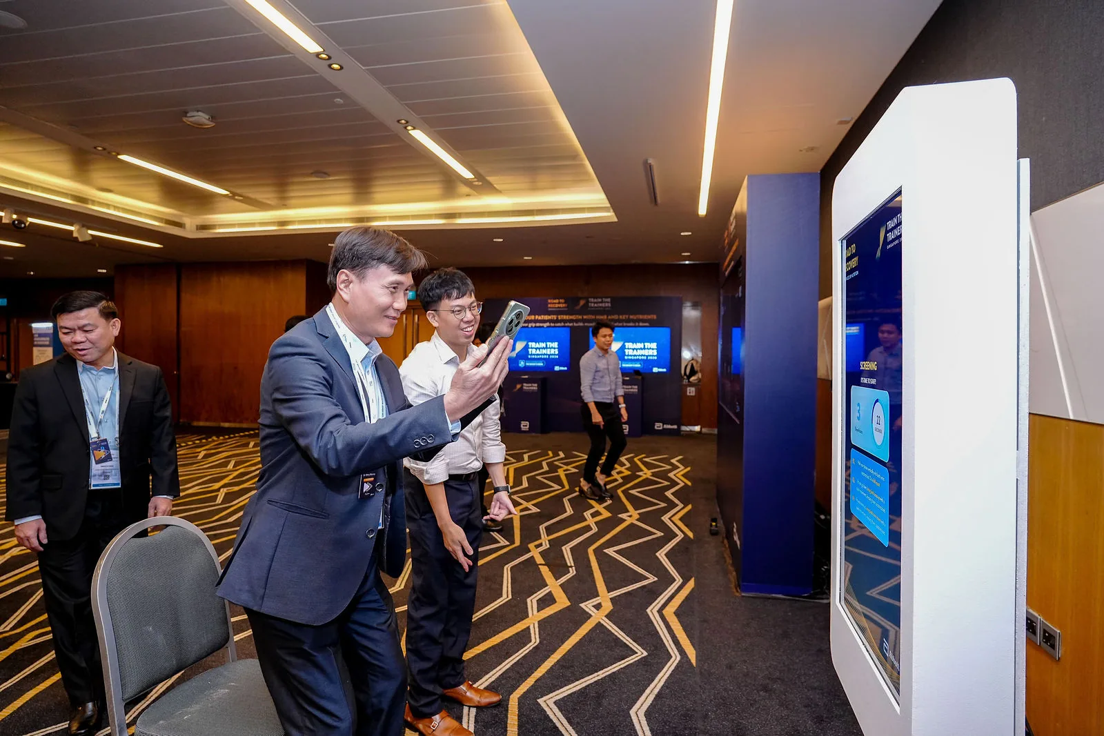 Conference delegates in conversation along a Suntec Singapore corridor — RS Photography